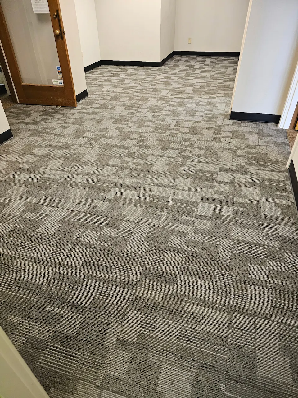 Patterned modular carpet tile installed in a commercial corridor