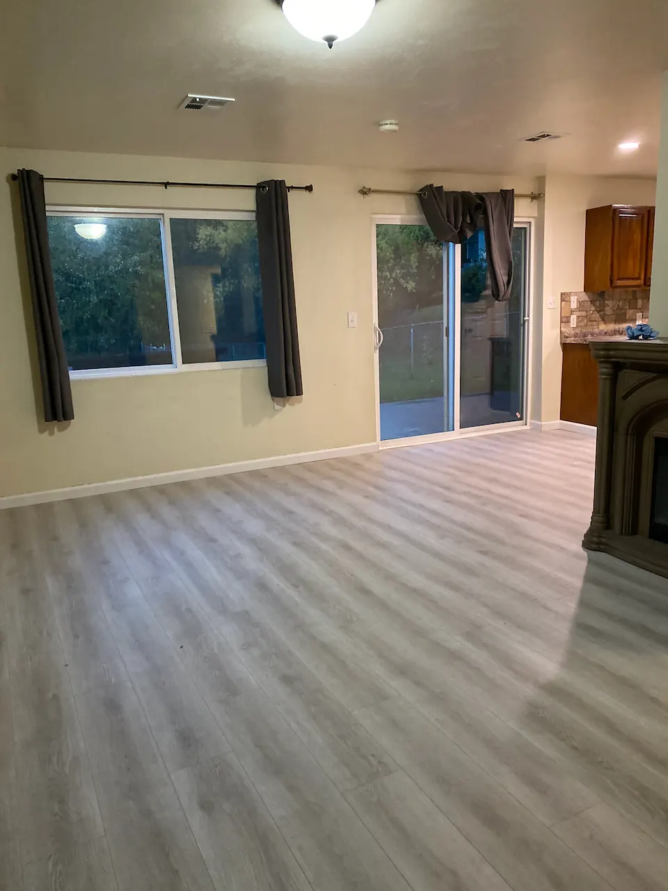 Grey wood-look luxury vinyl plank through an open-plan living room