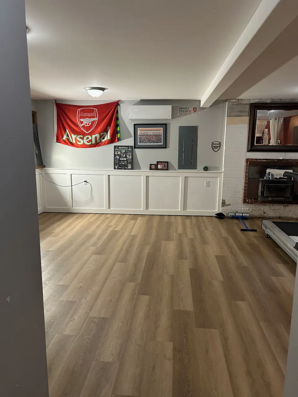Warm oak-look luxury vinyl plank in a finished lower-level living space